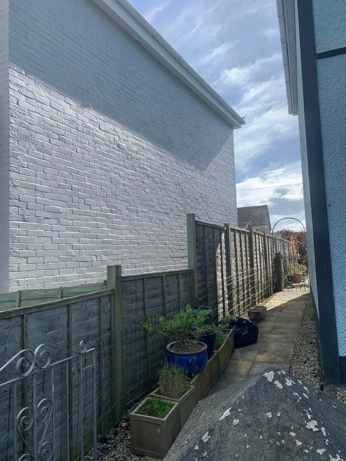 Freshly painted brick wall after preparation and masonry paint in Dawlish